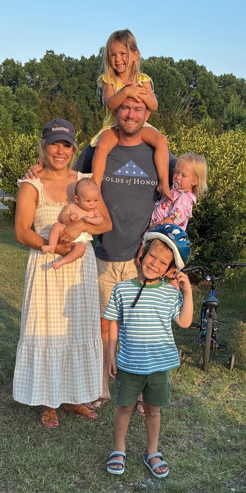 Tim Johnson with his wife and four kids outdoors